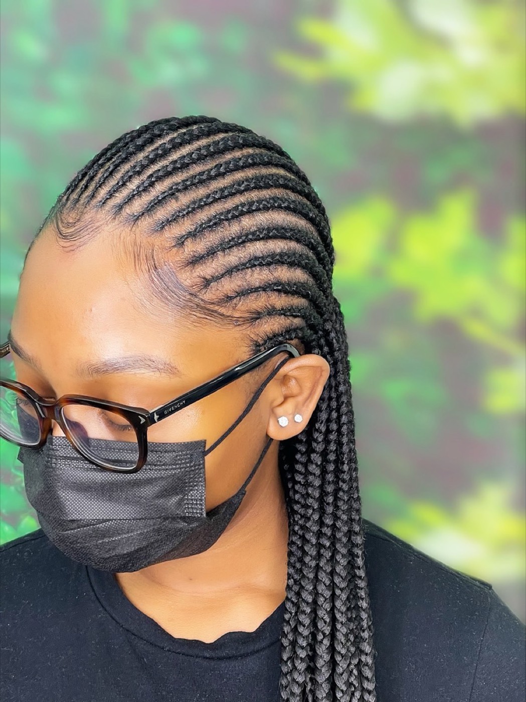 Sleek feed-in cornrows braided straight back into long braids, styled by Kaobell in Upton Park